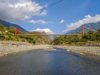 Road leading towards mountains against sky