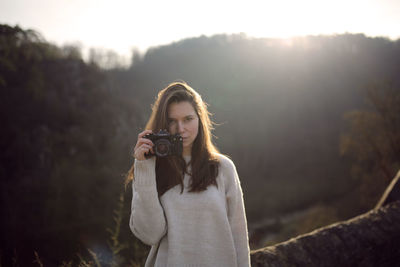 Young woman using mobile phone outdoors