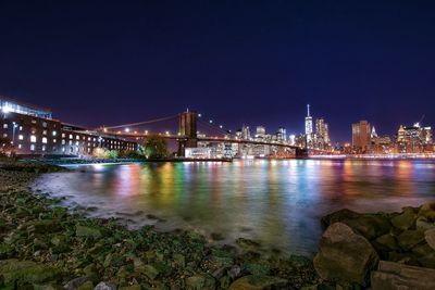 Suspension bridge over river at night