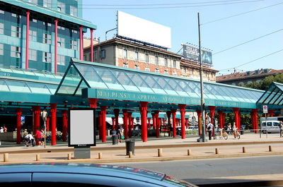 View of city street against blue sky