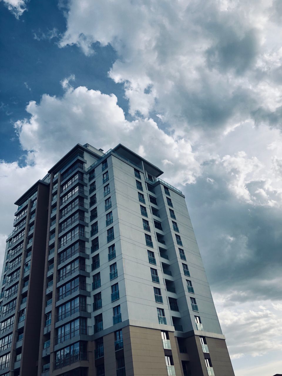 architecture, sky, built structure, building, cloud - sky, low angle view, building exterior, city, no people, modern, nature, office building exterior, day, tall - high, office, skyscraper, window, business, outdoors, city life, apartment, height