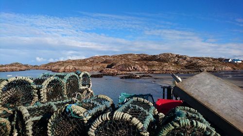 Crab cages by river against sky