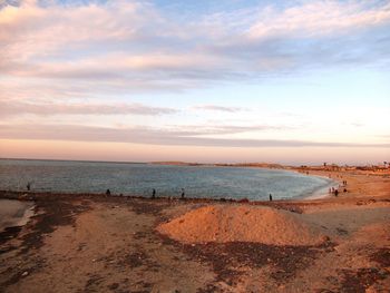Scenic view of beach against sky during sunset