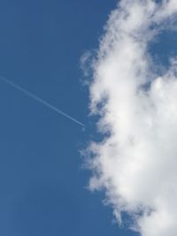 Low angle view of vapor trail in blue sky