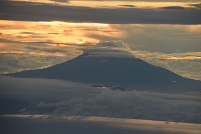 Aerial view of landscape against dramatic sky during sunset