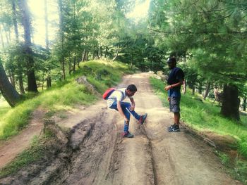 Full length of boy walking on footpath