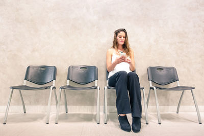 Portrait of woman sitting on chair