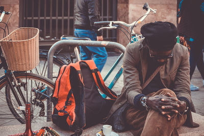 People sitting in basket on footpath