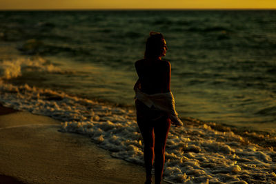 A girl by the ocean. dawn