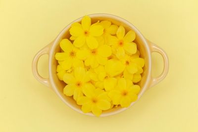 High angle view of yellow flowers in bowl