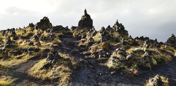 Low angle view of rock formation against sky