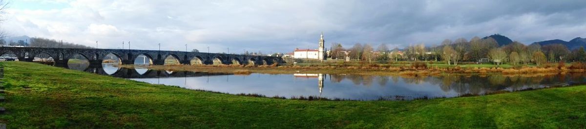 Panoramic view of trees and grass against sky