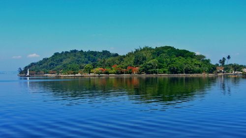 Scenic view of lake against clear blue sky