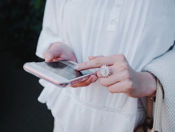 Close-up of woman holding mobile phone