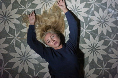 Directly above shot of young woman lying on floor