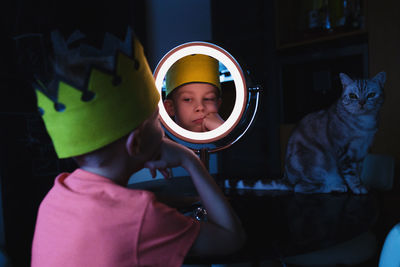 Close-up of boy looking in mirror
