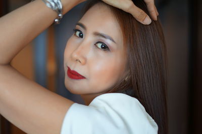 Portrait of woman wearing red lipstick at home