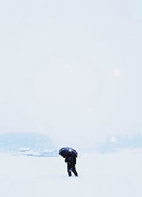 People standing on snow covered field