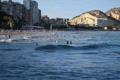 Group of people on beach in city
