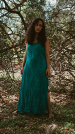 Portrait of young woman standing in forest