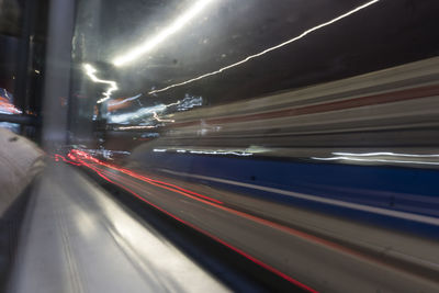 Light trails on train in city at night