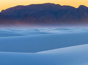 Scenic view of snow covered mountains against sky