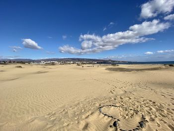 Scenic view of beach against blue sky