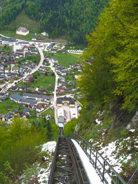 High angle view of railroad tracks amidst trees in city