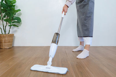 Low section of man standing on hardwood floor