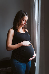 Pregnant woman standing at home