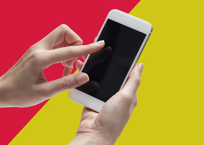 Close-up of hand holding mobile phone