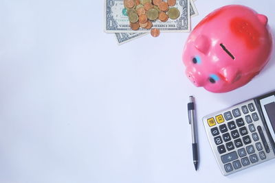 Close-up of coins on table against white background