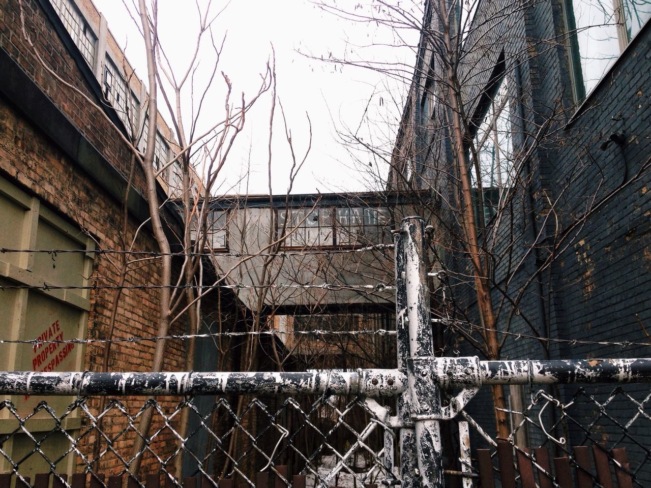 architecture, building exterior, built structure, damaged, abandoned, metal, house, obsolete, old, window, residential structure, fence, deterioration, run-down, chainlink fence, building, residential building, day, weathered, roof