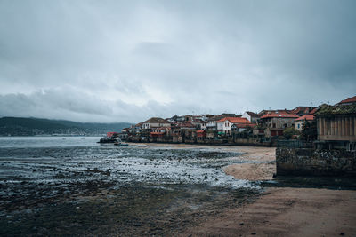 Sea and buildings against sky