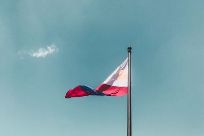 Low angle view of philippines flag waving against sky