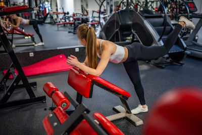 Side view of woman exercising in gym