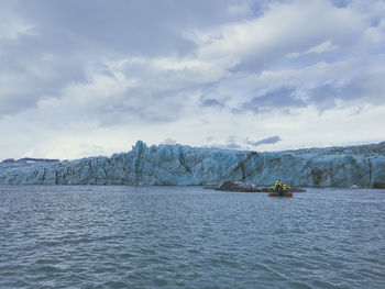 Boat sailing in sea against sky