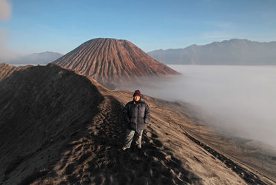 Mature woman standing on mountain