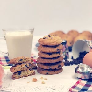 Close-up of chocolate chip cookies and milk on table