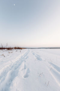 Scenic view of snow covered land against clear sky