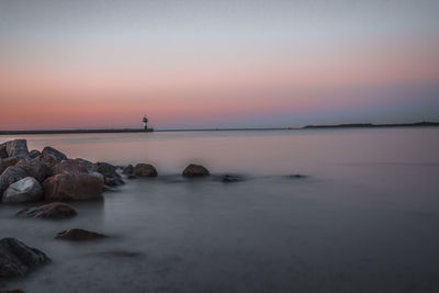 Scenic view of sea against sky at sunset