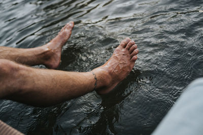 Low section of man legs by sea