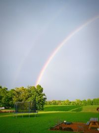 Scenic view of rainbow over field