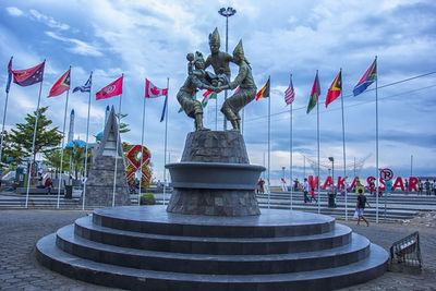 Statue of flags against sky