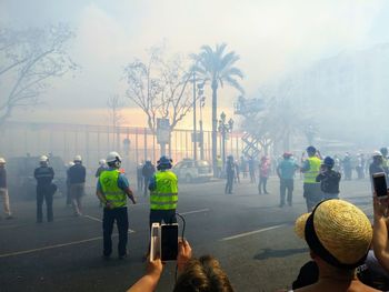 People standing against fire in city