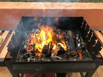 High angle view of fire on barbecue grill