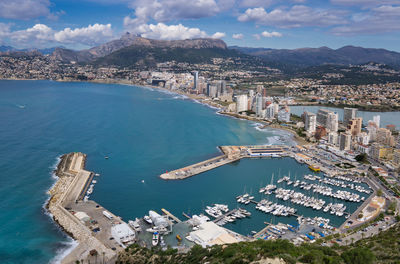 High angle view of townscape and sea against sky