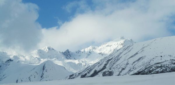 Scenic view of snowcapped mountains against sky