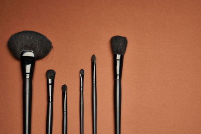 Make-up brushes on brown table
