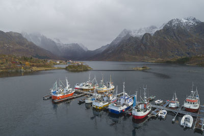 Boats docked in port in lofoten fjords from drone view